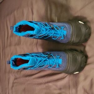 Blue and black North Face boots